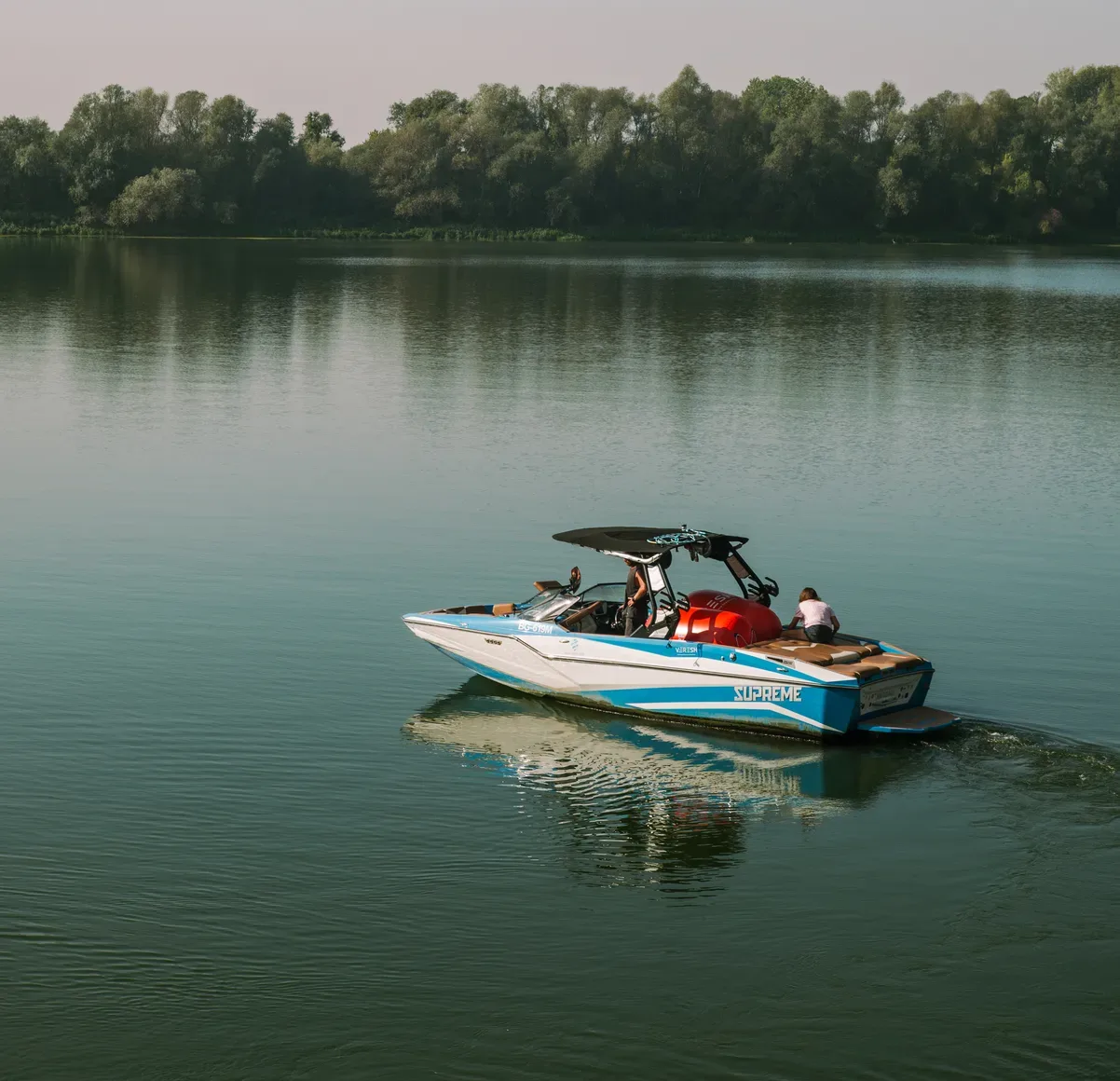 Wake boat cruising across a calm lake, ready for a coaching session